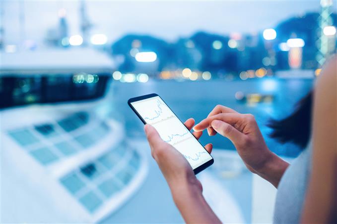 woman checking forex charts on mobile phone